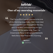 kefirlab Focus Dreamsicle probiotic shot bottles on fabric base, white caps