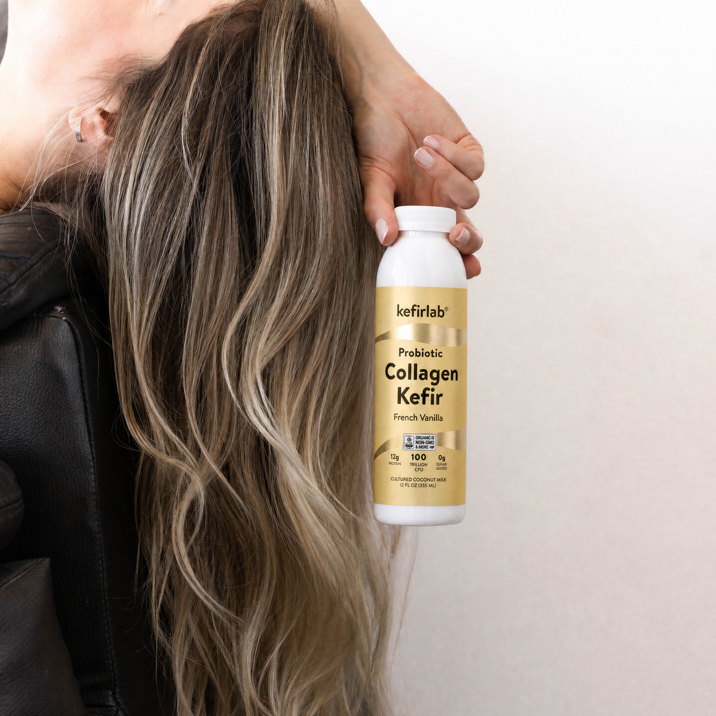 Collagen kefir drink bottle with French vanilla label, held in hand