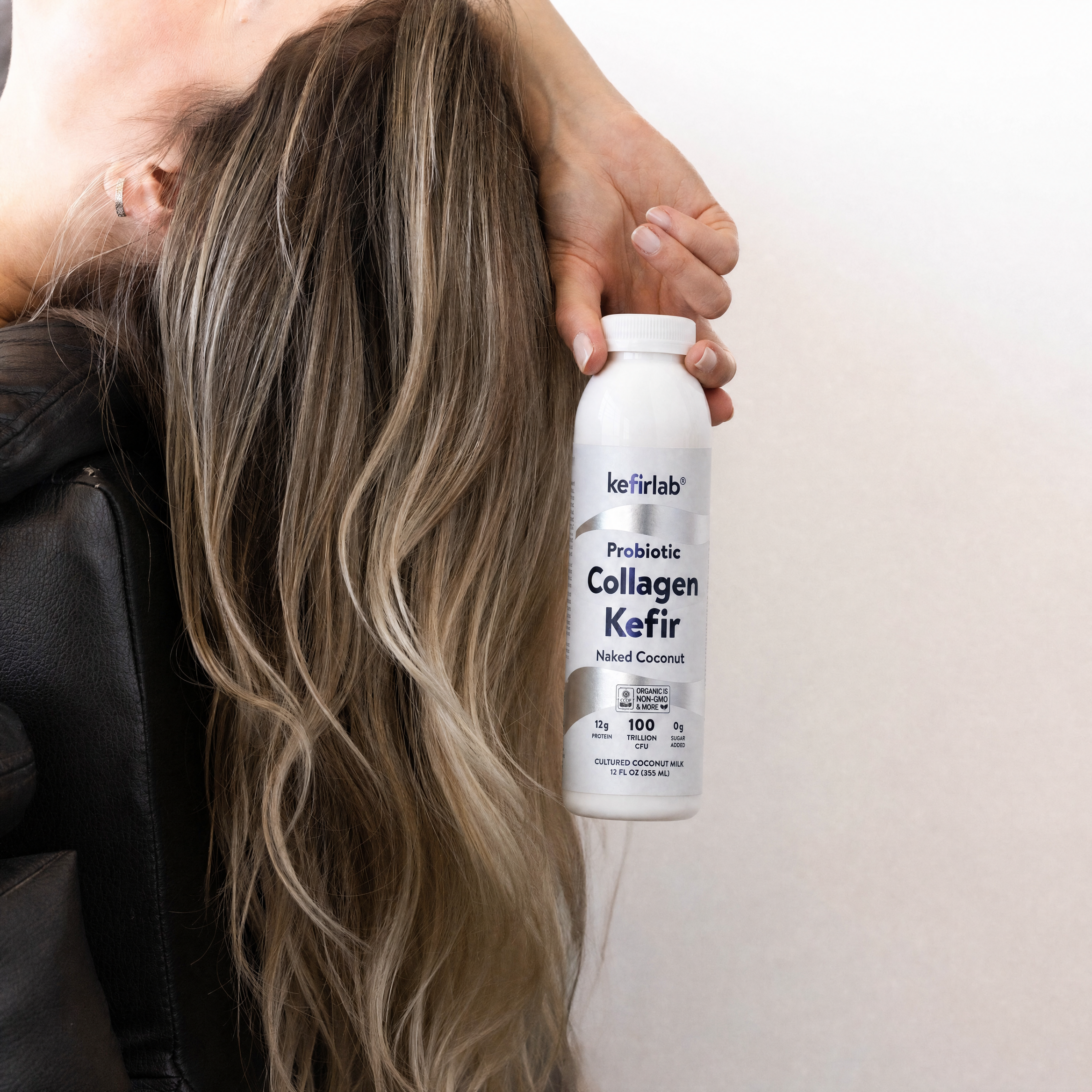 KefirLab probiotic collagen kefir bottle, white label in hands