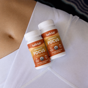 Two kefirlab Focus probiotic shot bottles with amber labels and white caps