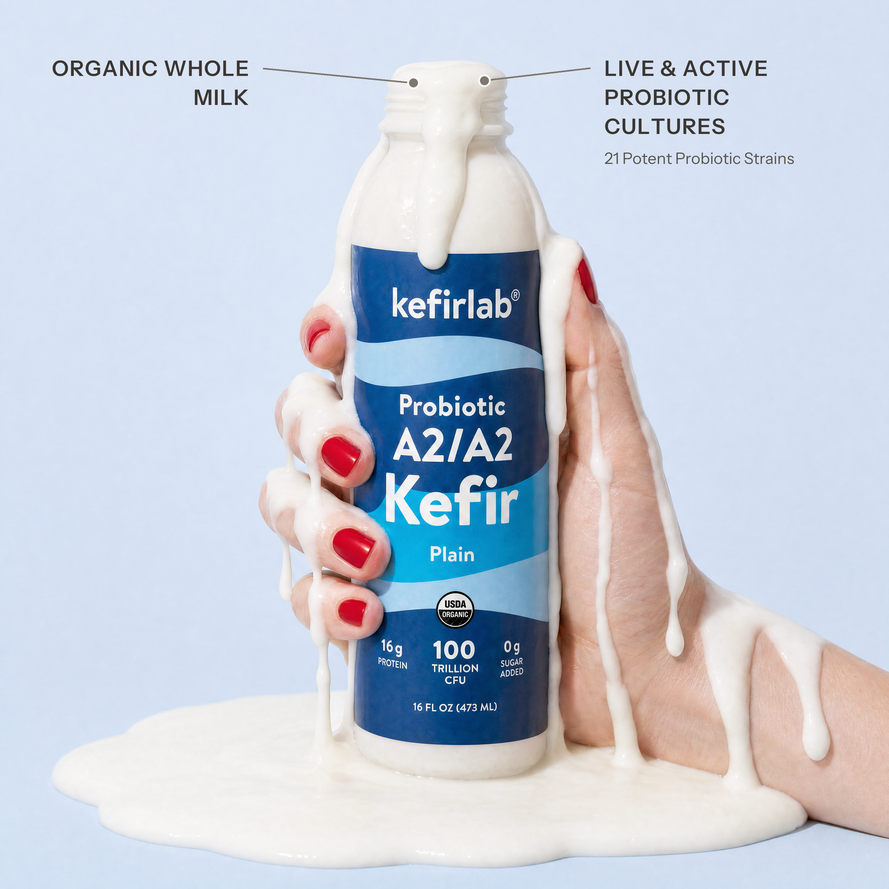 kefirlab Probiotic A2/A2 kefir bottle with blue label, cap and pour of milk