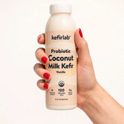 kefirlab probiotic coconut milk kefir vanilla bottle in hand, cream label front