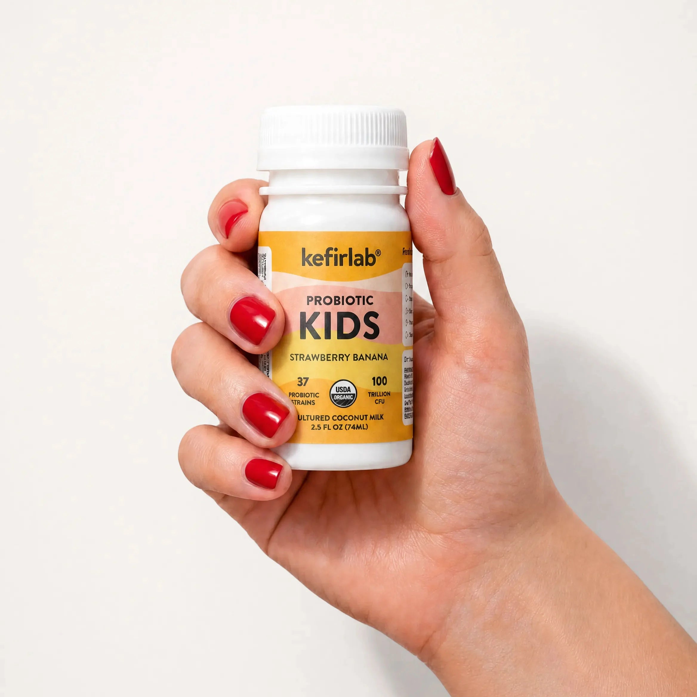 Kefirlab Kids probiotic shot bottle, white cap, strawberry banana flavor, yellow label