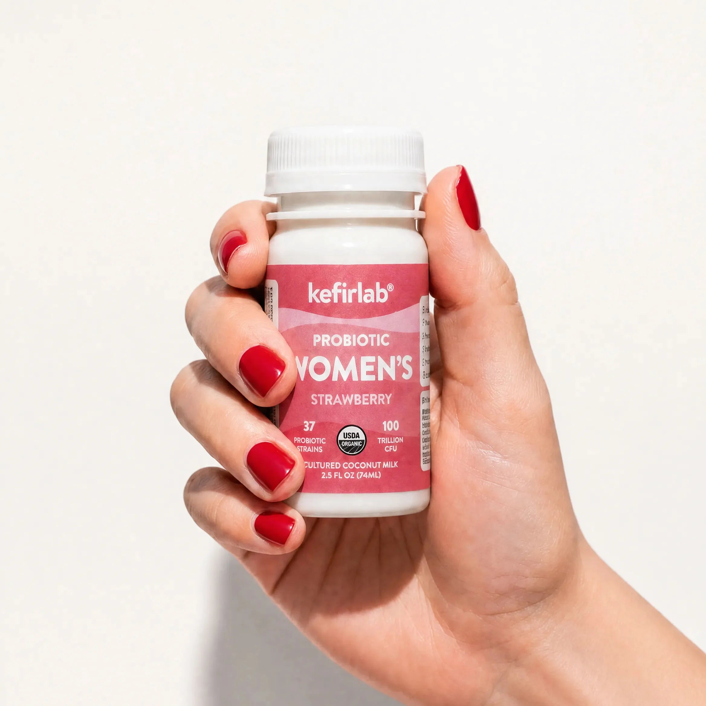 kefirlab women’s probiotic strawberry drink bottle, white cap, pink label